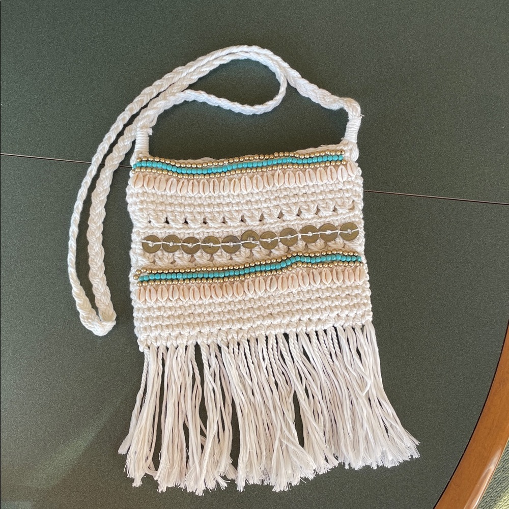 Crossbody purse with beads and shells .  100 percent cotton.